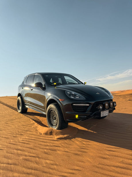 Lifted Porsche Cayenne 958 GTS with Akioverland aki 04 Custom Forged Mesh Wheels Driving in the Desert, Saudi Arabia